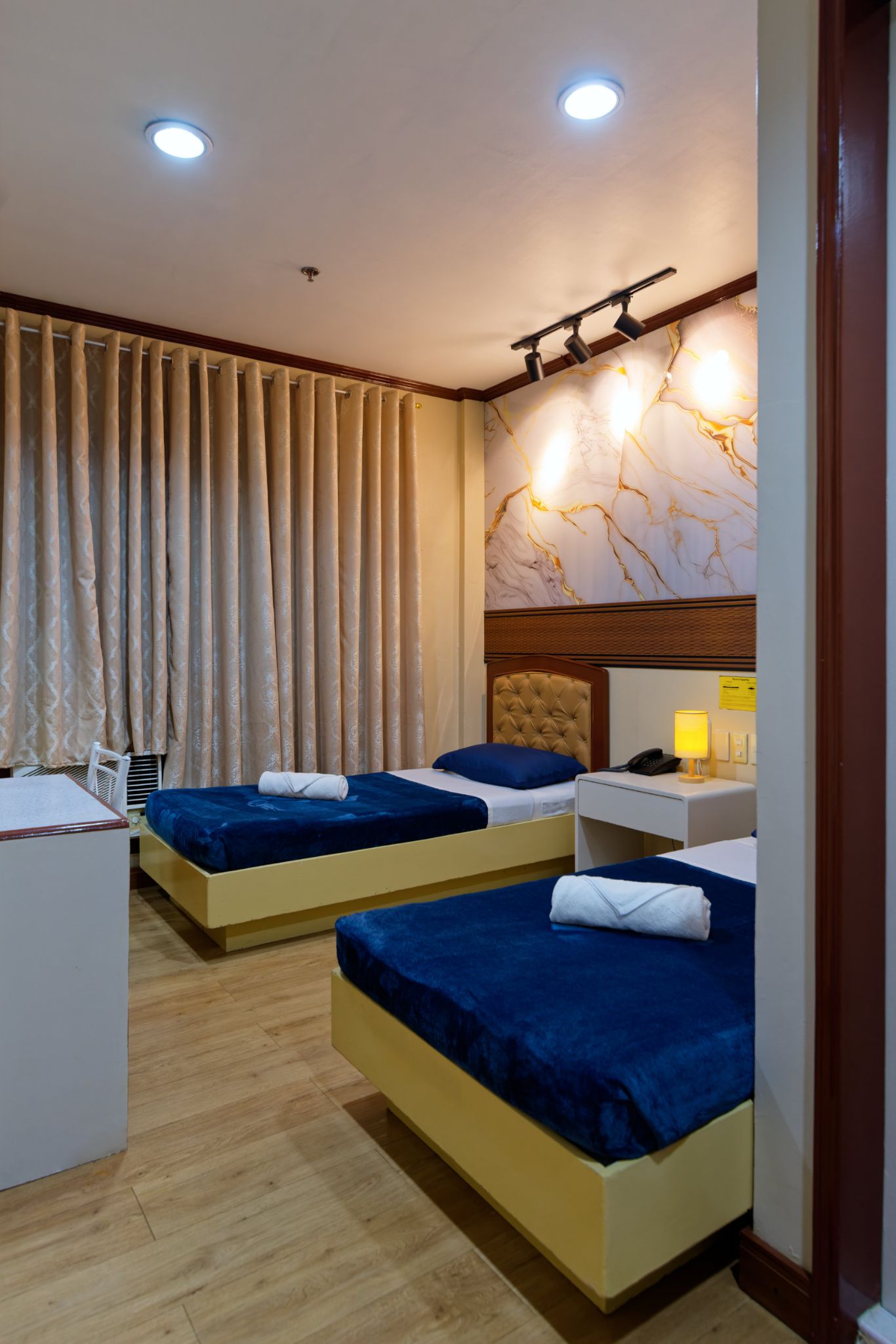 Room 202 twin beds marble feature wall track lighting
